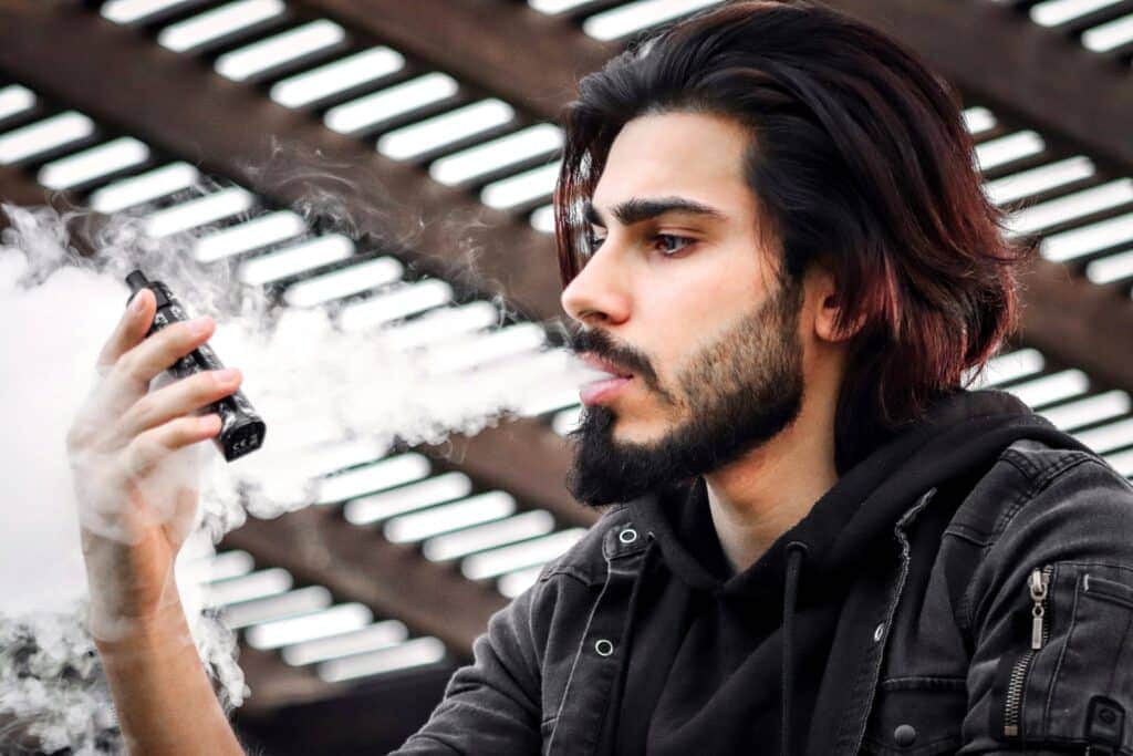 A man vaping delta 8 THC