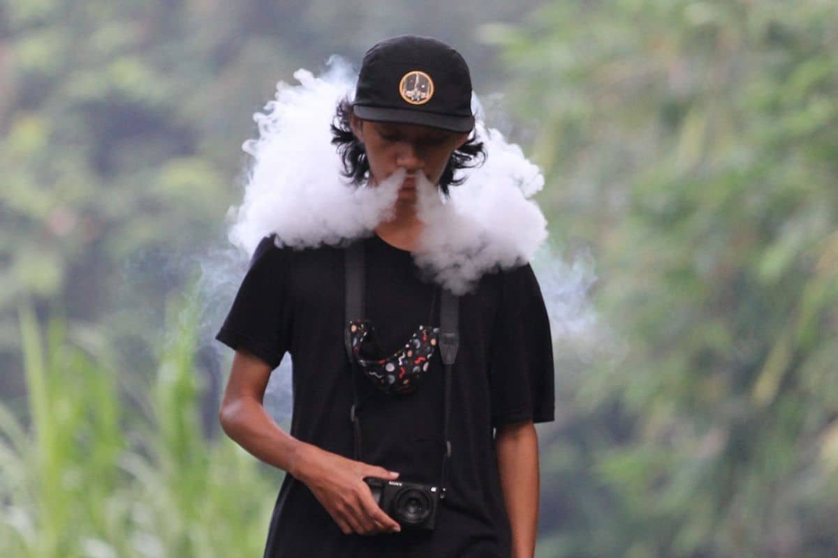 Man walking while vaping THC