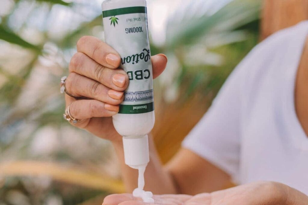 Woman applying CBD lotion
