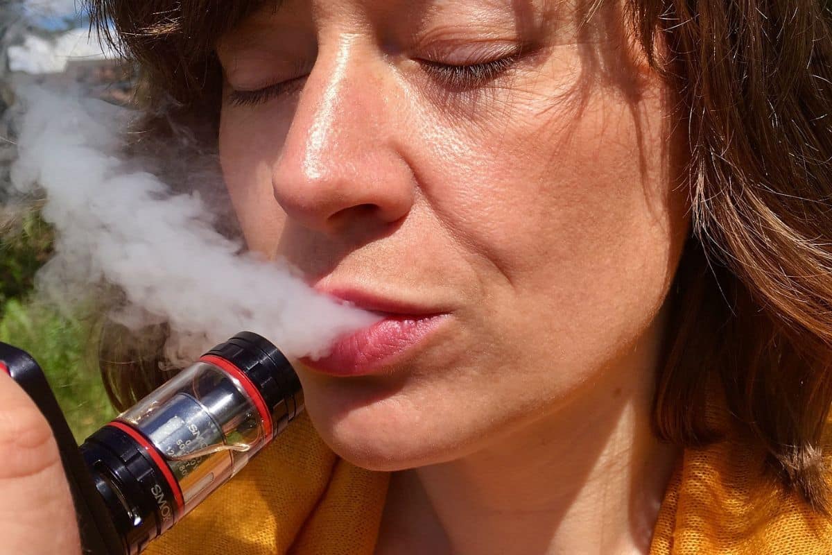 Woman vaping delta 8 THC