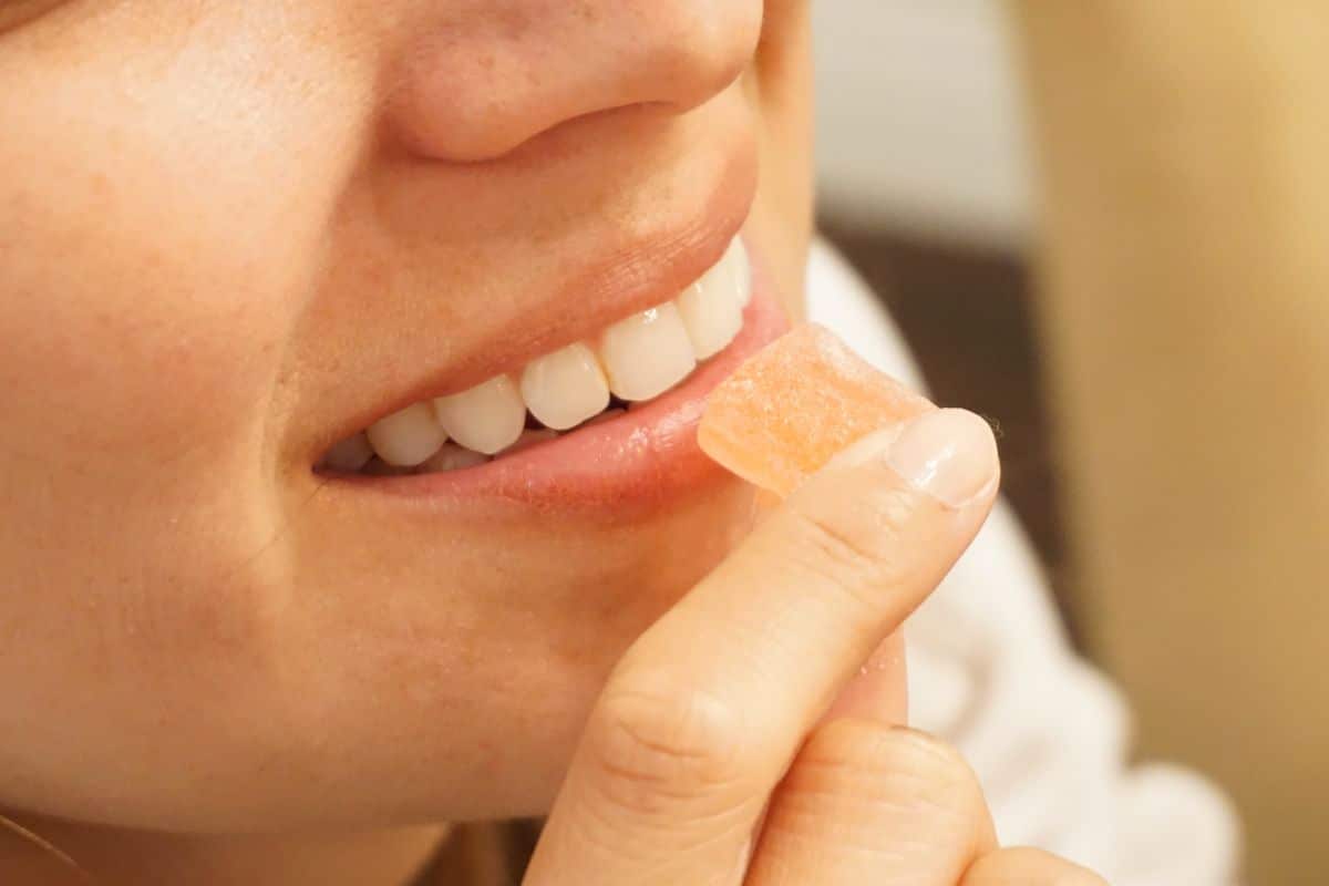Woman having delta 8 THC gummies Woman having delta 8 THC gummies