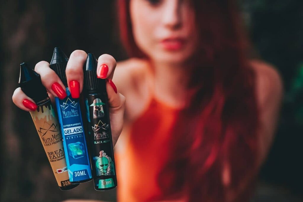 A lady holding vape juices