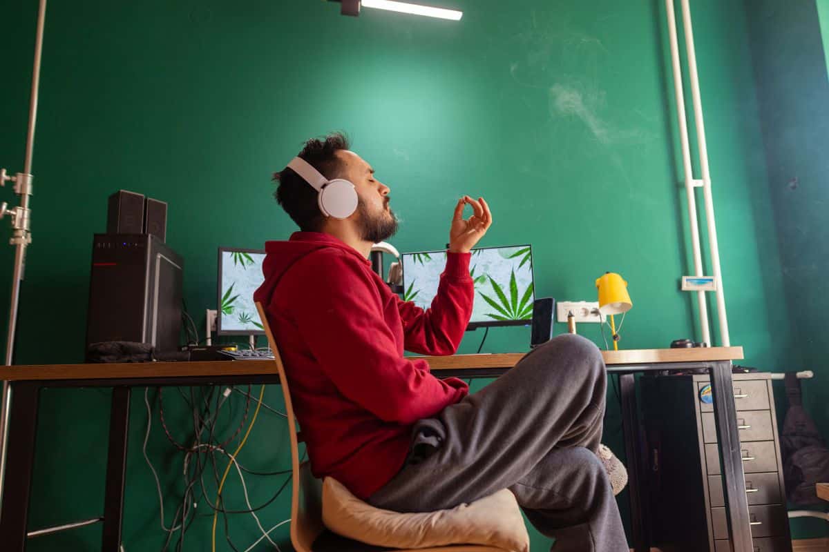 A guy smoking weed at home