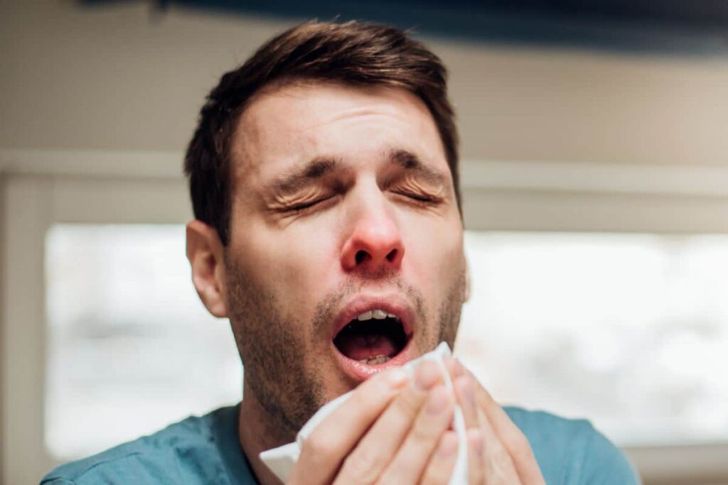 A guy sneezing after smoking delta 8