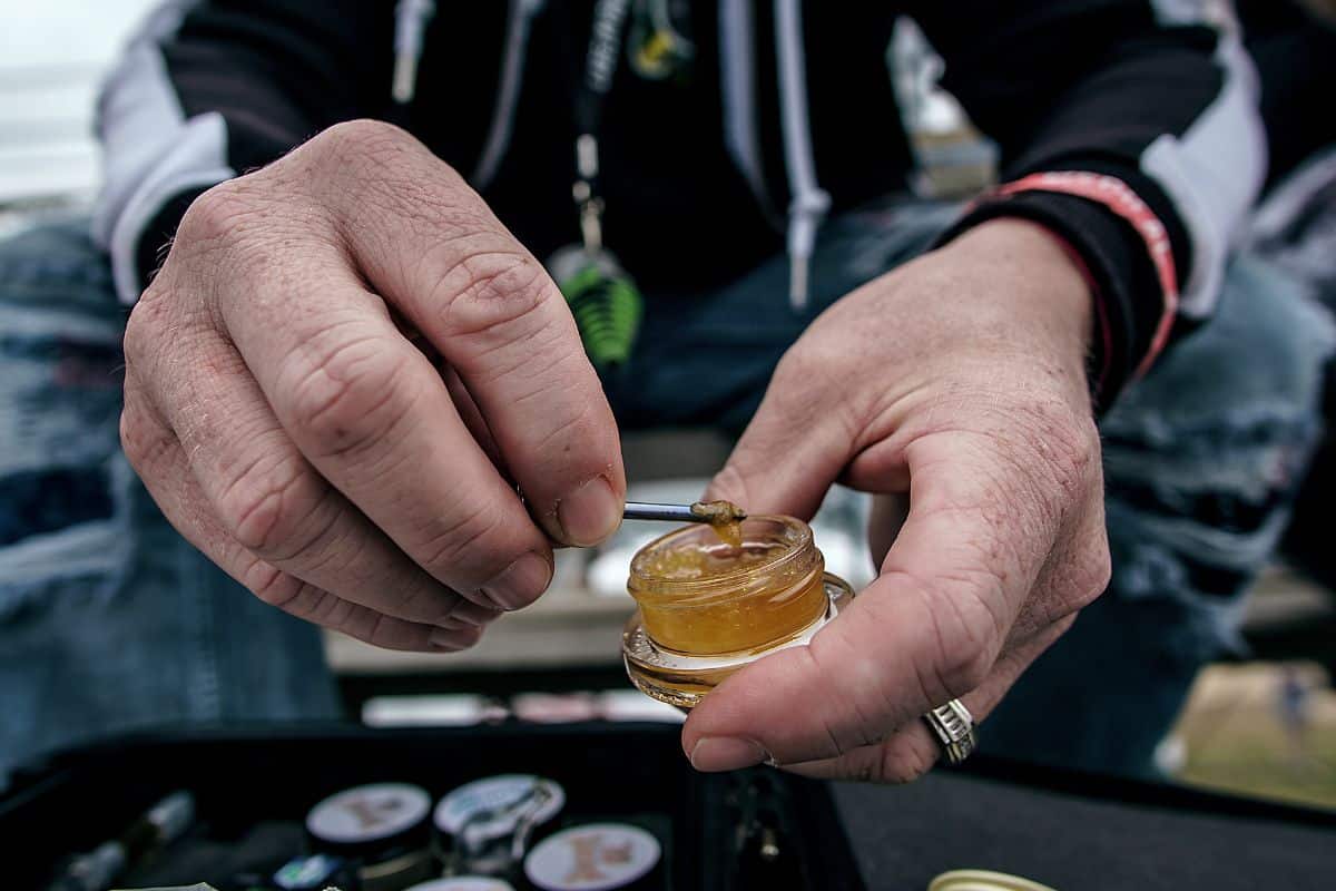 A man showing thca sand's different uses for smoking and vaping.