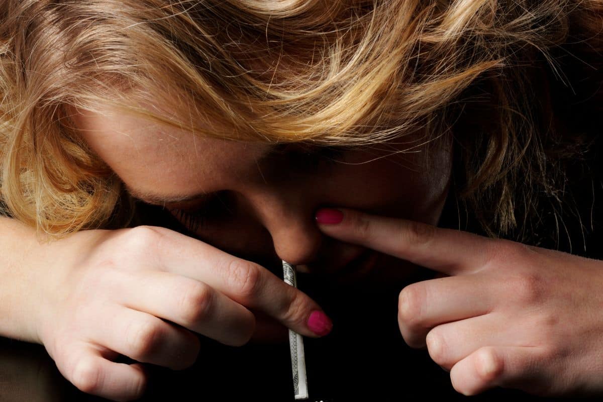 A woman snorting weed A woman snorting weed