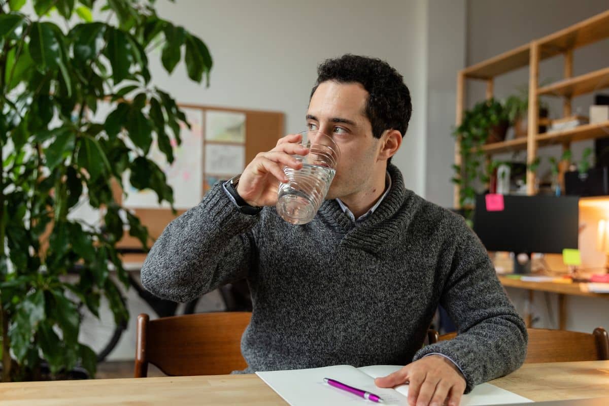 A guy drinking plenty of water to get rid of delta 8 from his body