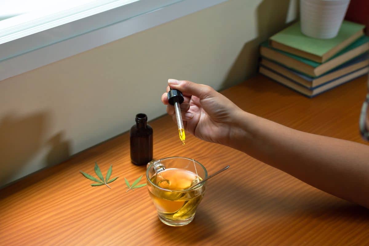 A lady having delta 8 tincture with her tea A lady having delta 8 tincture with her tea
