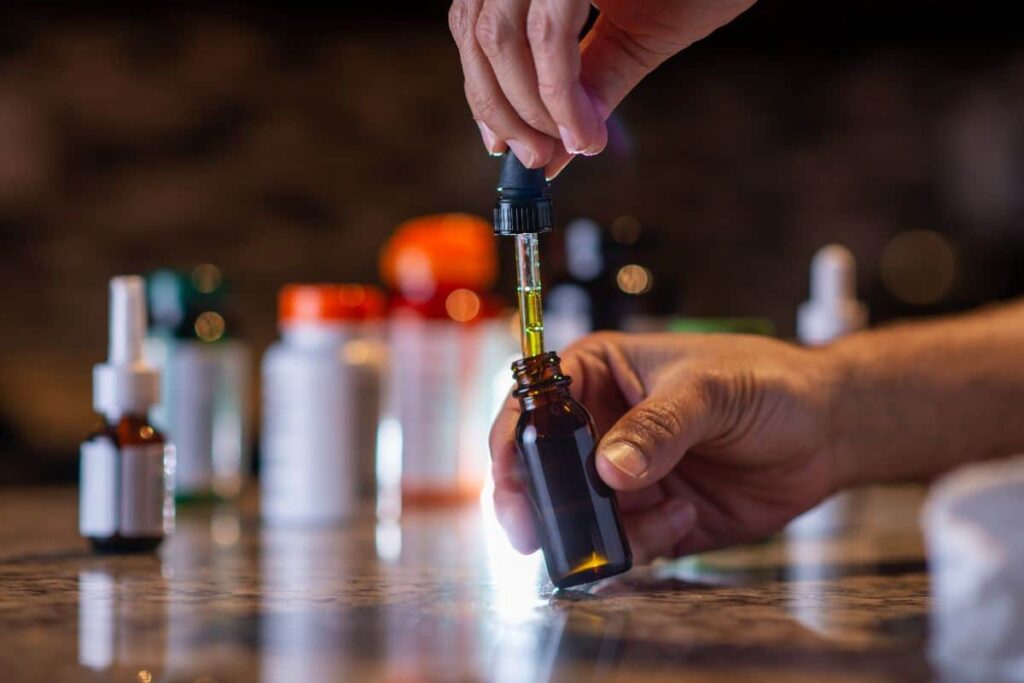 A man holding delta 8 tincture bottle in his hand