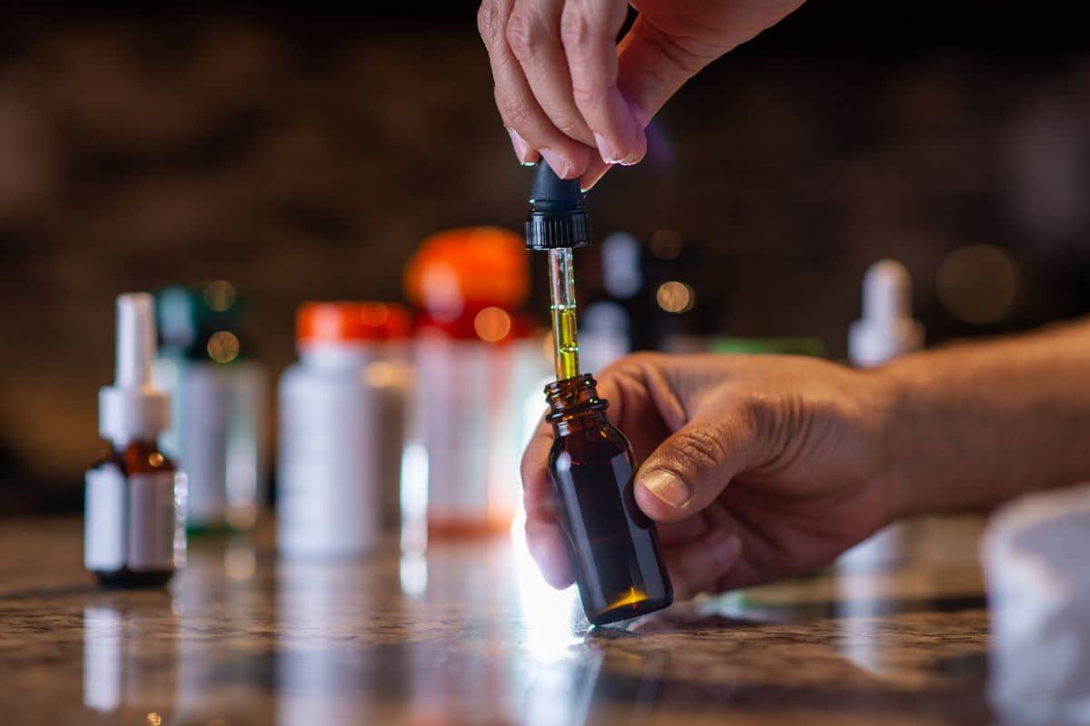 A man holding delta 8 tincture bottle in his hand