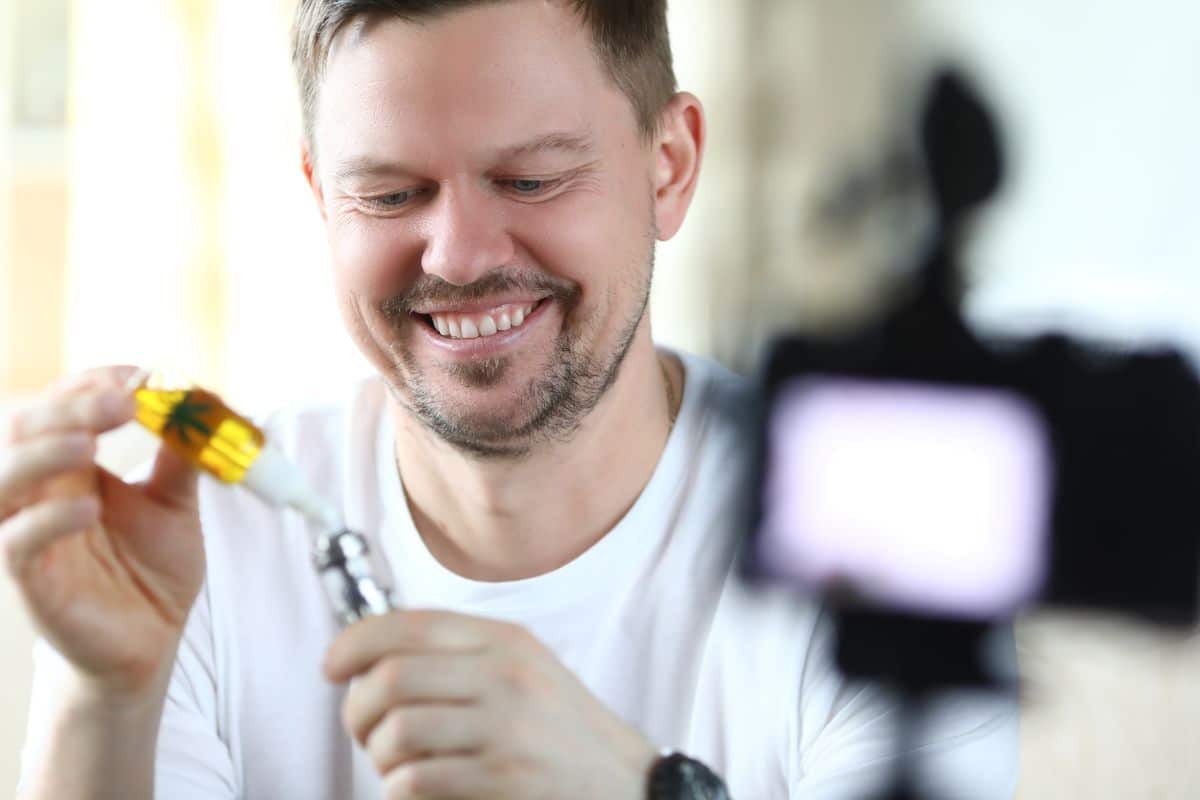 A guy filling empty vape cart A guy filling empty vape cart