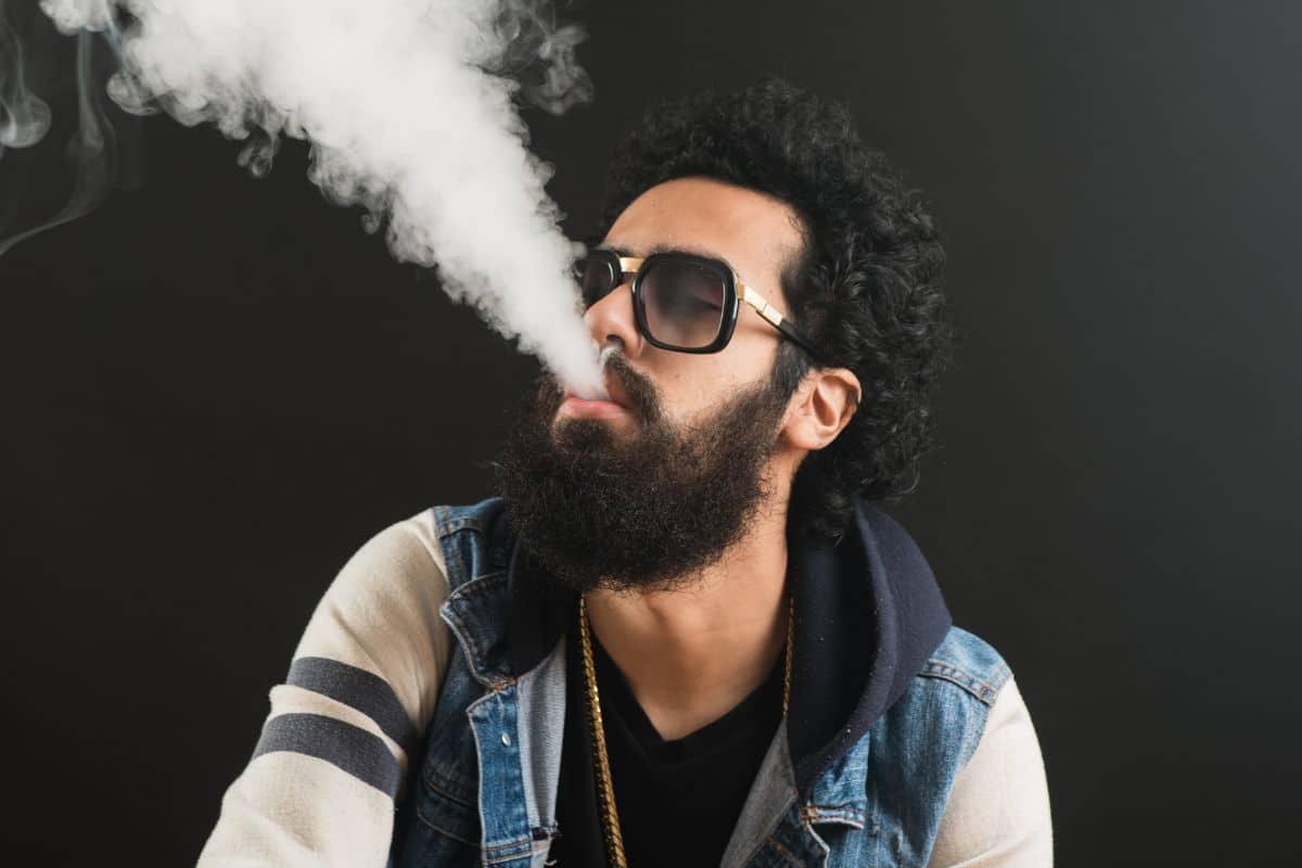 A guy using Delta 9 disposable vape pen A guy using Delta 9 disposable vape pen
