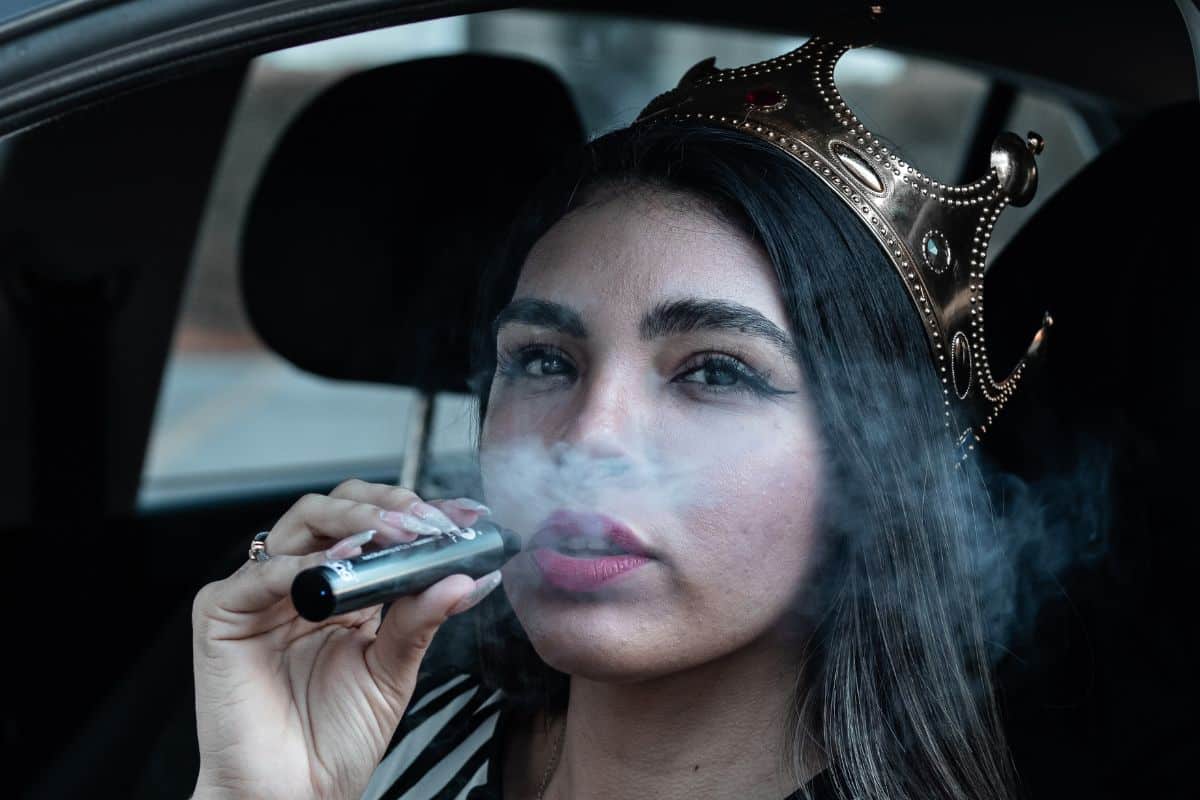 A lady vaping delta 9 inside a car A lady vaping delta 9 inside a car