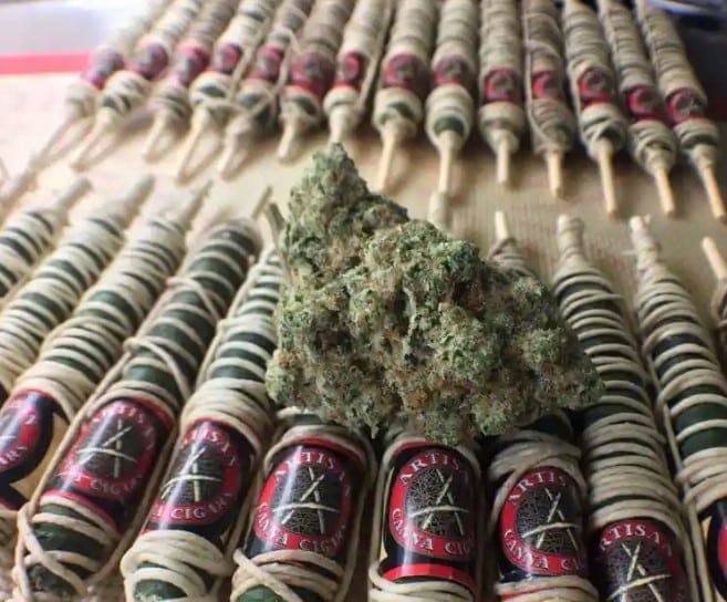 A bunch of Thai stick marijuana on a table.