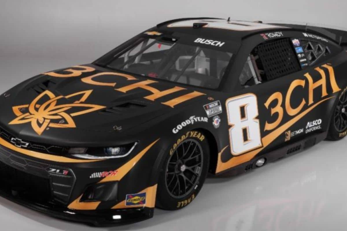 A Chevrolet Camaro featuring a sleek black and gold design, reminiscent of 3Chi in NASCAR.