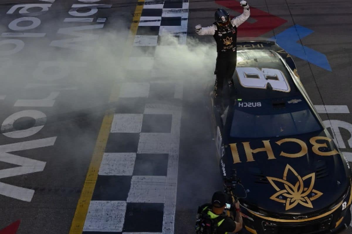 A Nascar car emitting smoke, including the 3chi brand.