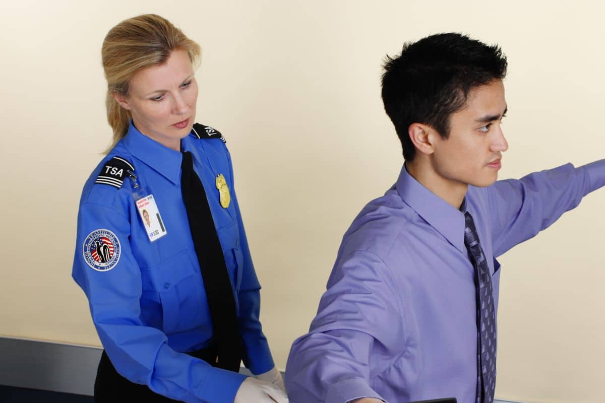 A TSA official checking for cbd products at the airport A TSA official checking for cbd products at the airport
