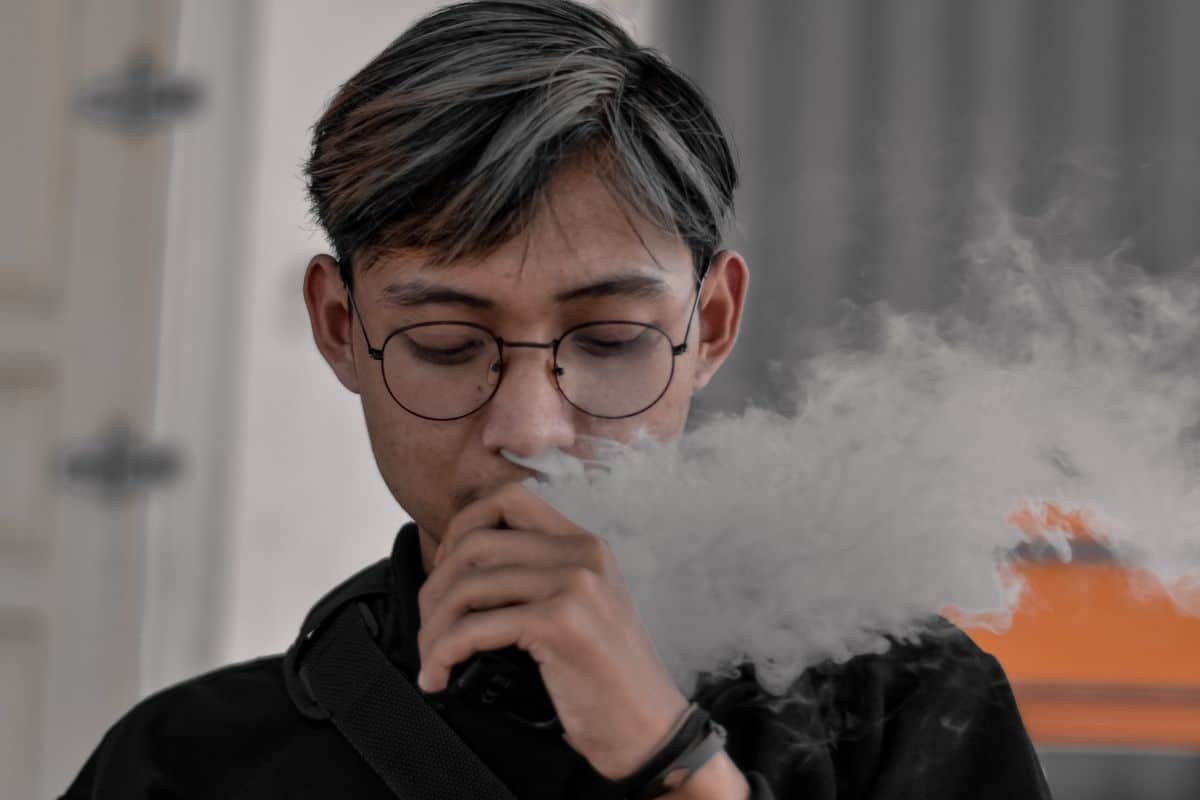 A guy vaping 3Chi's Comfortably disposable vape A guy vaping 3Chi's Comfortably disposable vape
