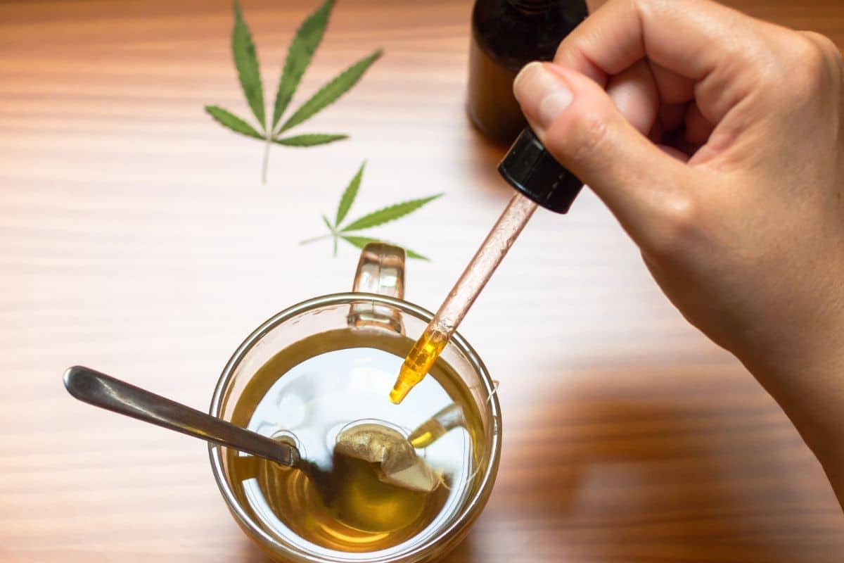 A man adding delta 9 tincture in his tea
