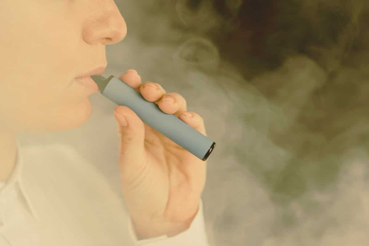 A man using long lasting Elf Bar disposable vape