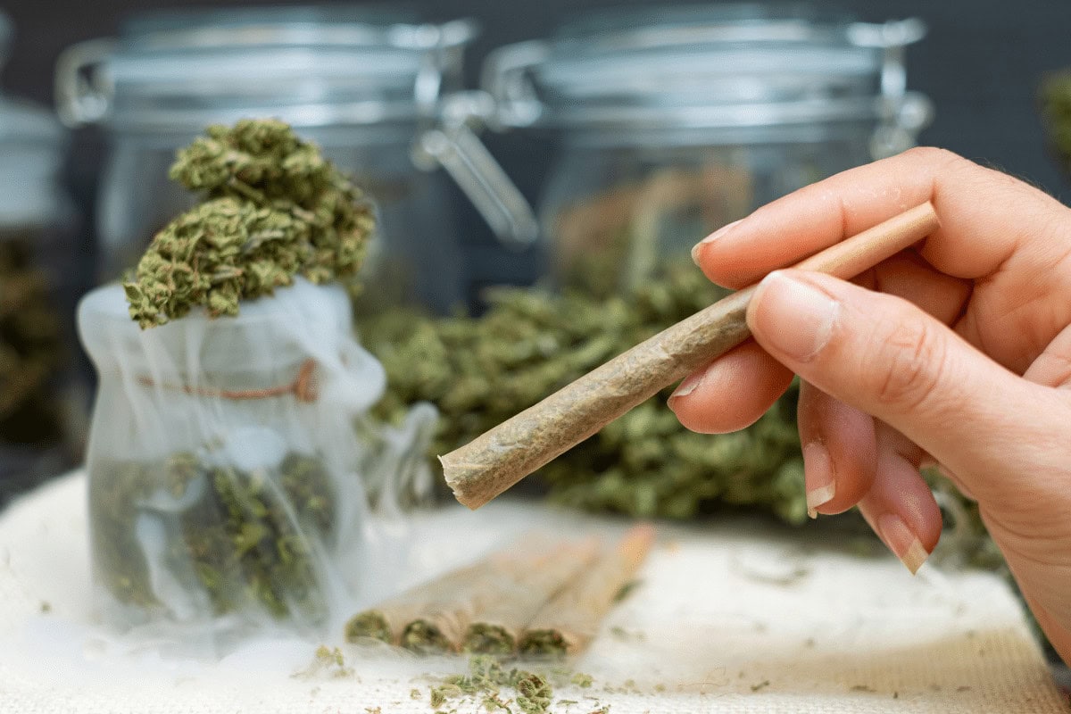 A woman holding a pre roll in her hand A woman holding a pre roll in her hand