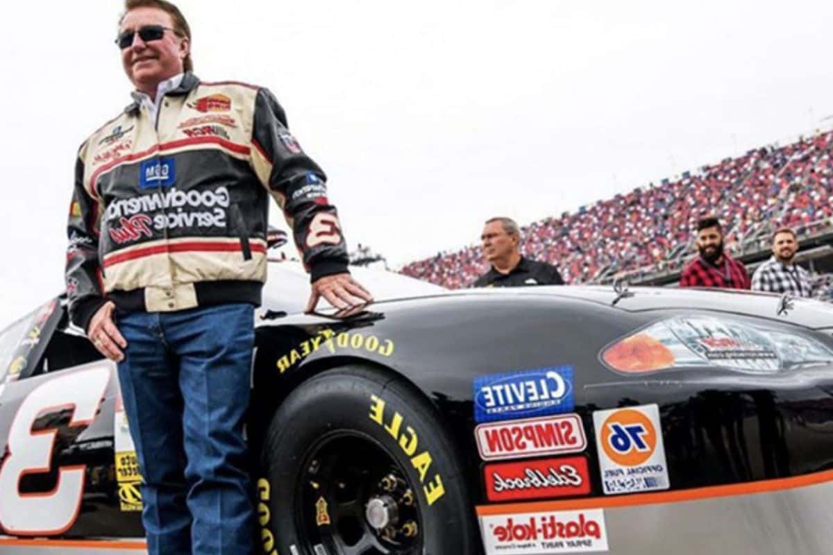Richard Childress standing next to a NASCAR car, featuring 3chi