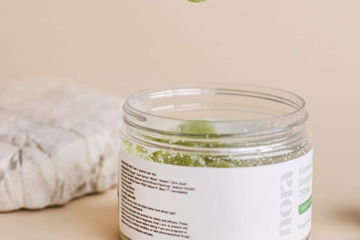 THC gummies inside a glass jar with all the lables on it THC gummies inside a glass jar with all the lables on it