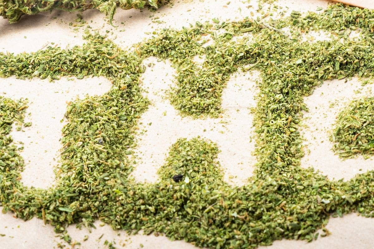 THC written on the floor with weed powder