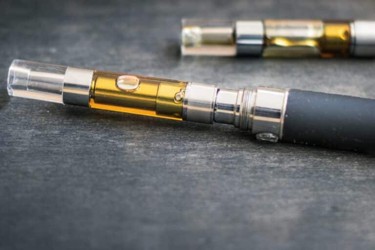 Two e-cigs, one with a 5 gram cartridge and the other with a 1 gram cartridge