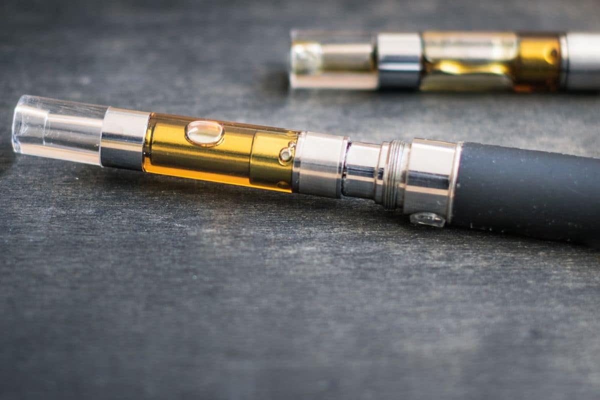 Two e-cigs, one with a 5 gram cartridge and the other with a 1 gram cartridge
