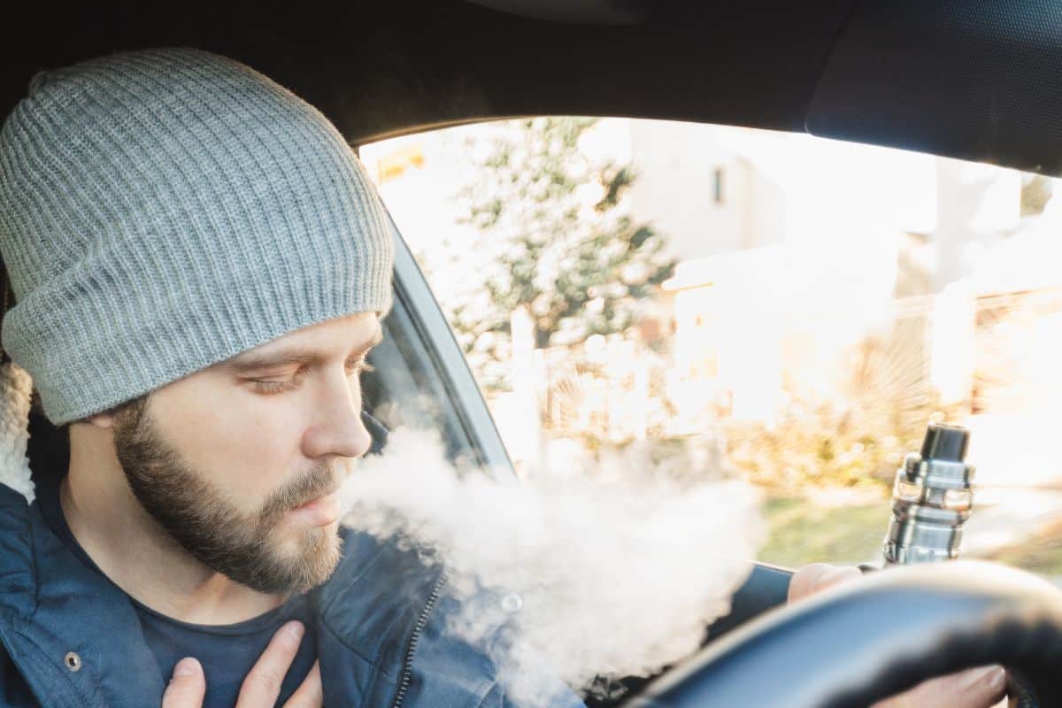 A guy enjoying vaping inside a car A guy enjoying vaping inside a car