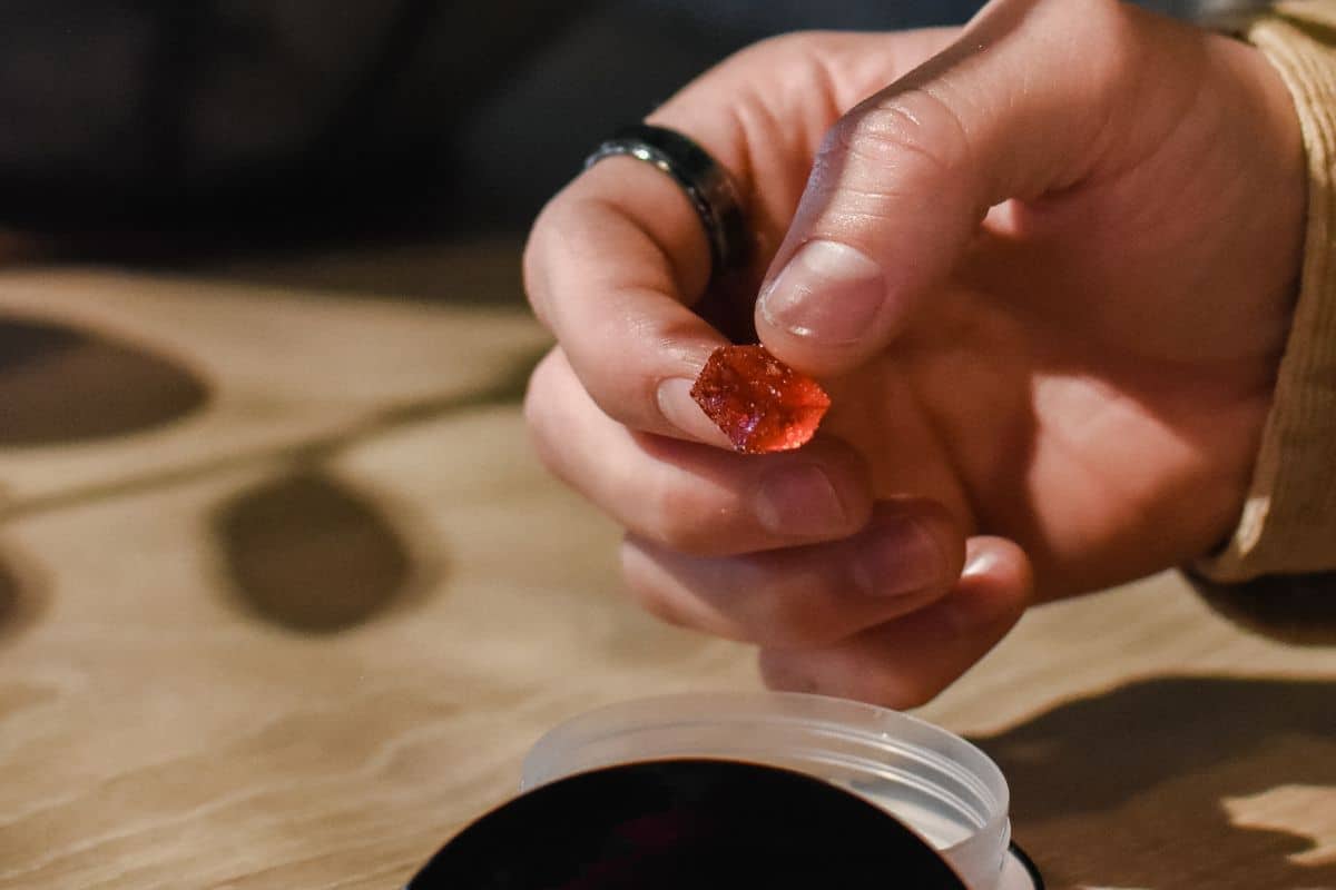 A woman holding Shruumz Gummies in her hand A woman holding Shruumz Gummies in her hand