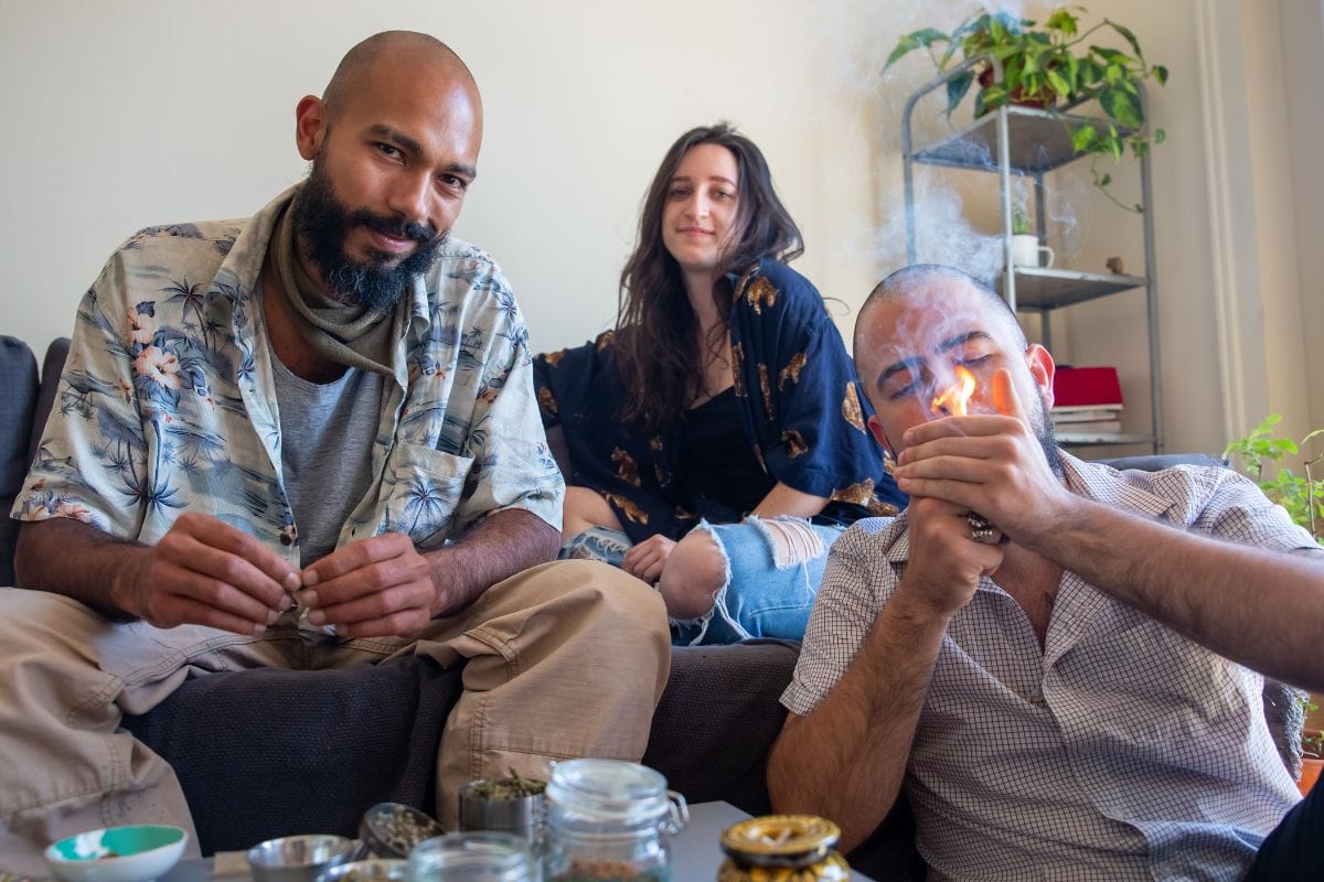 Two guys smoking weed in front of their non smoker friend