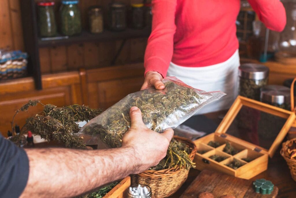 A woman is handing a bag of THCa to a man in Illinois.