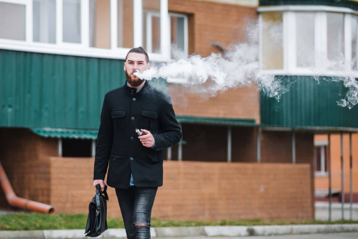 A guy vaping to calm his mind and to relax himself.