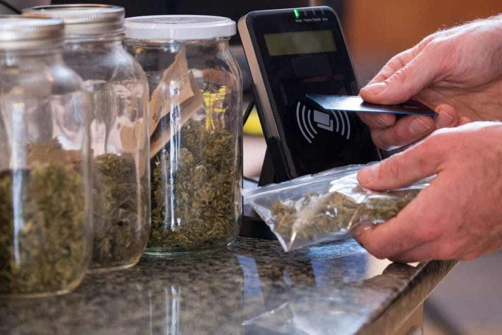 A person is using a credit card to pay for marijuana, in Nebraska.