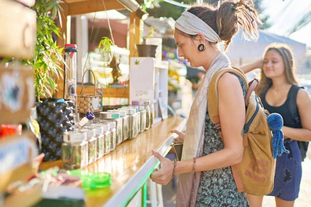 A women buying marijuana from a shop.