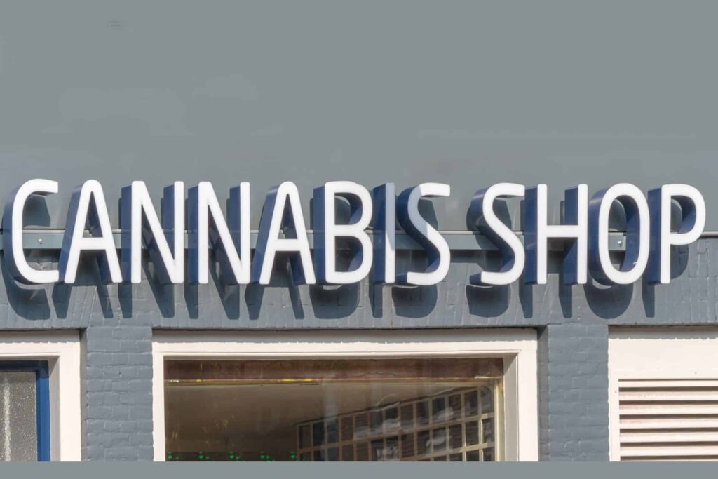 A sign that says cannabis shop on the side of a building in Illinois.