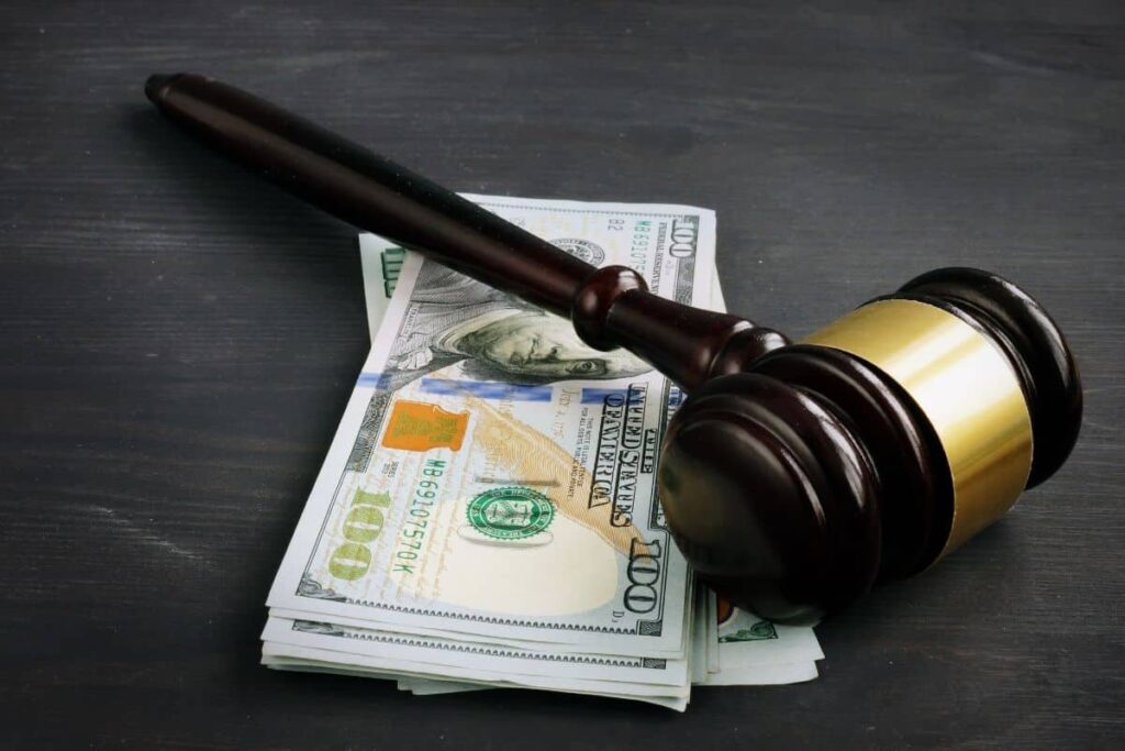 Gavel kept on money depicting financial penalty.