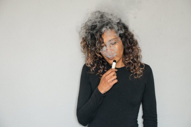 A Woman using Vape without a pen