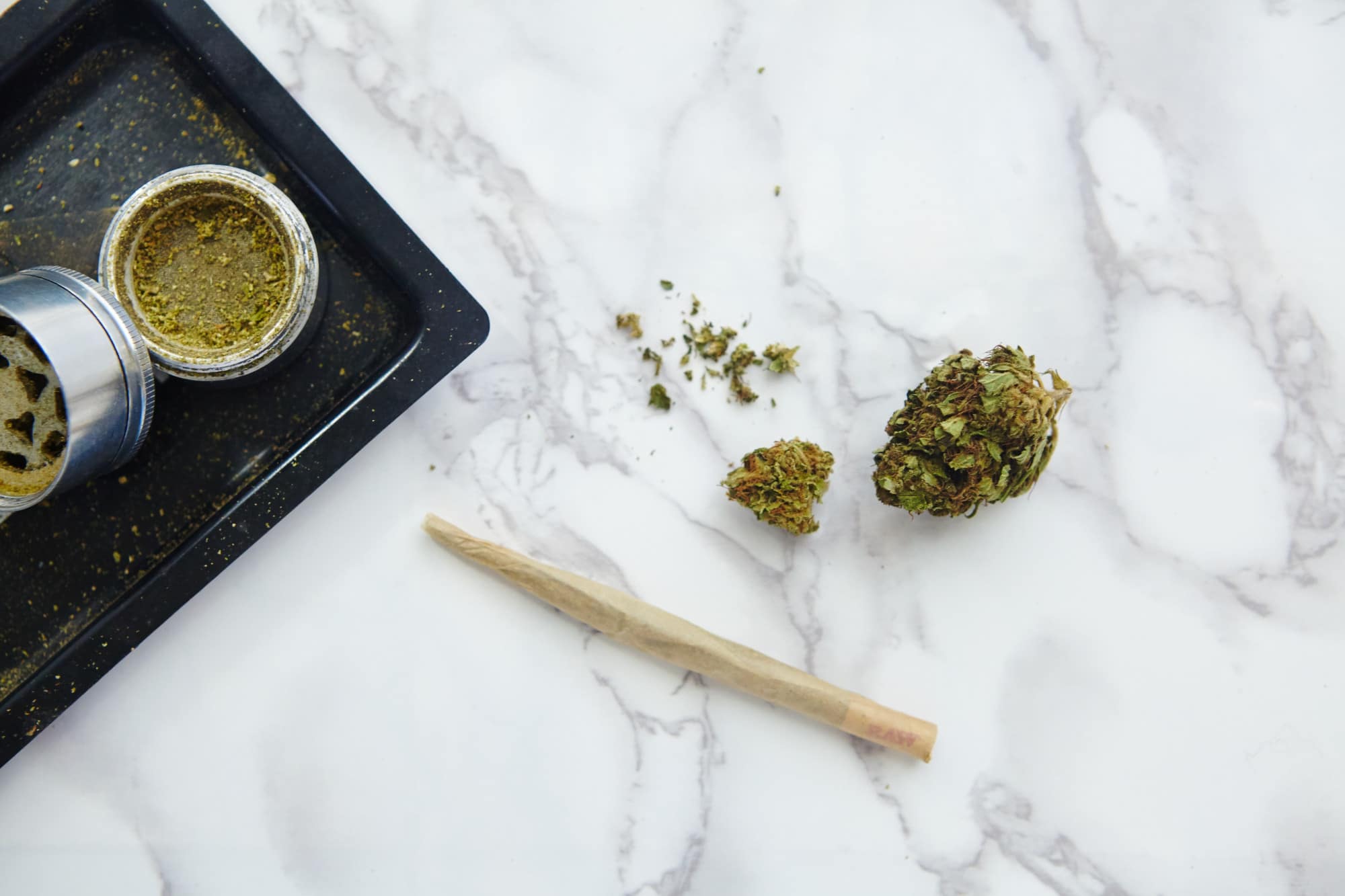 A tray with marijuana and a pipe on it, ready for some high hits.