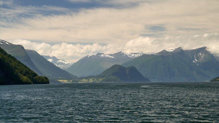 A legal large body of water in Alaska with mountains in the background.