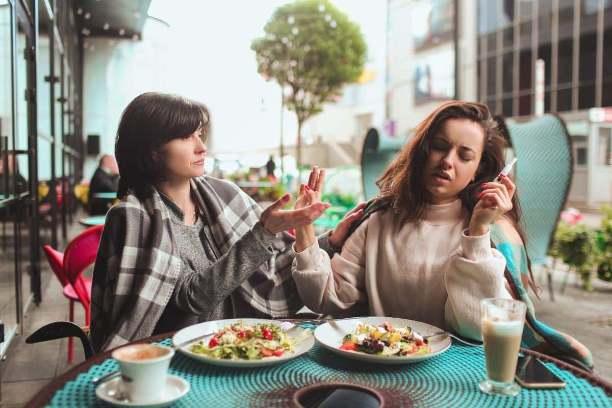 A lady vaping and eating more because of the effects of vaping