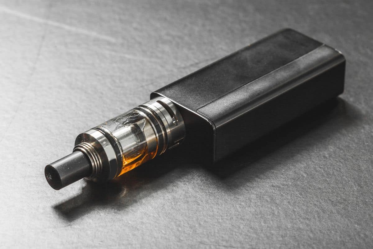 A Delta 8 disposable vape cartridge is sitting on a table.