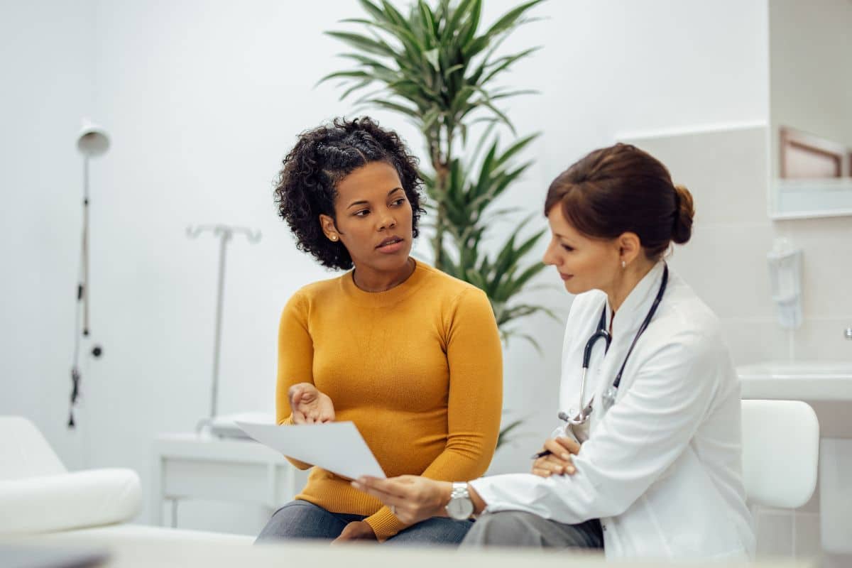 A woman with a high THCa level is talking to a doctor in a doctor's office about her hair test results.