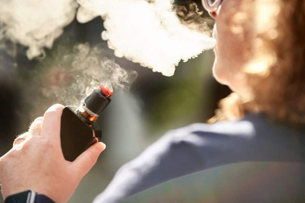 A woman is experiencing a THCa flower through vaping.