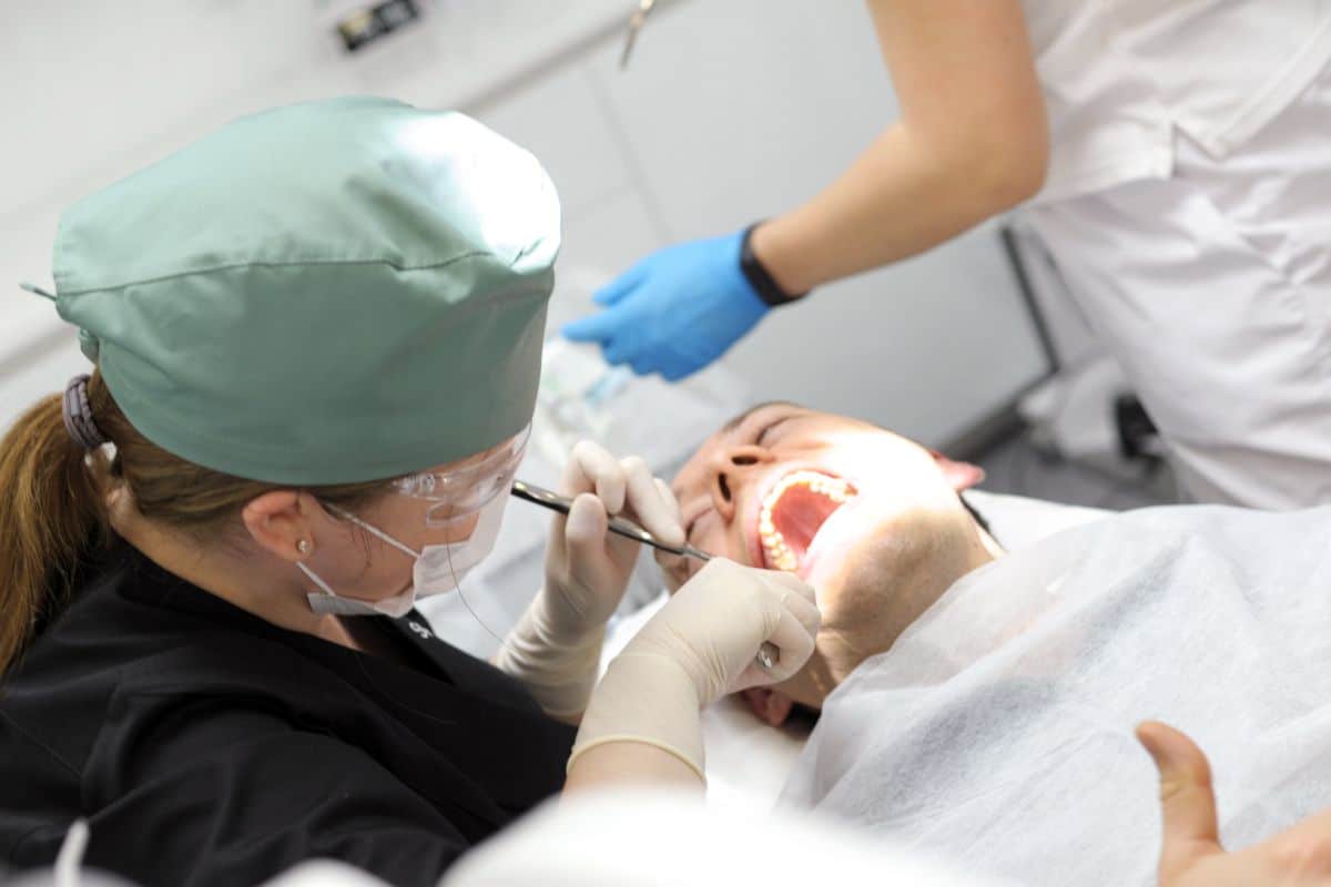 A dentist is examining a patient's teeth when they ask, "When can I vape after wisdom teeth removal?