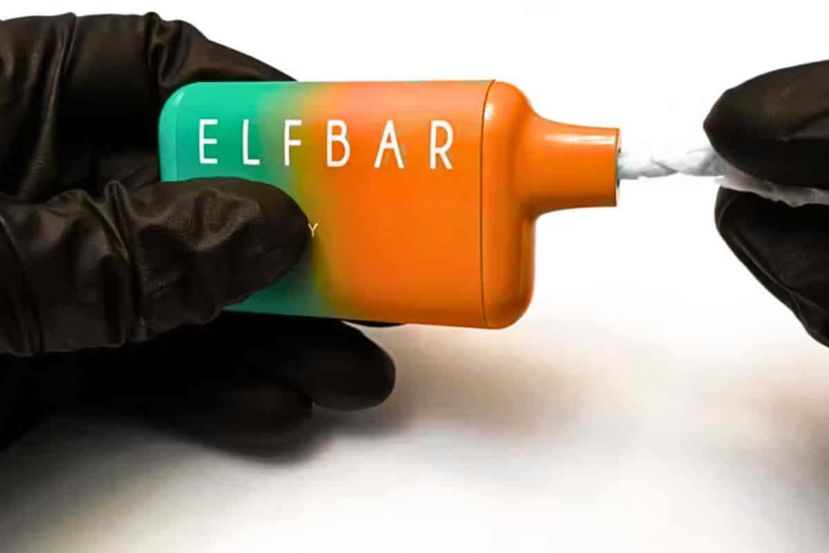 A guy cleaning elf bar vape's mouth piece.