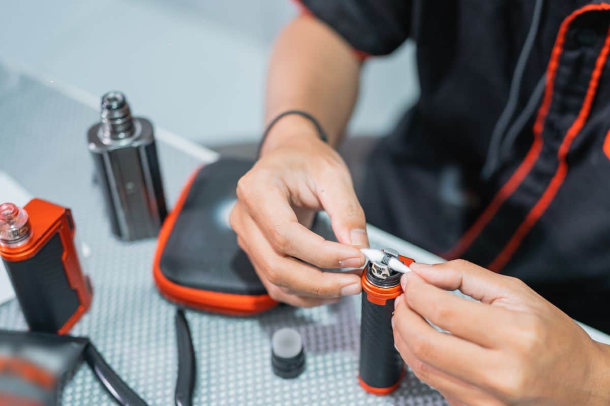 A guy cleaning vape coil and reusing it