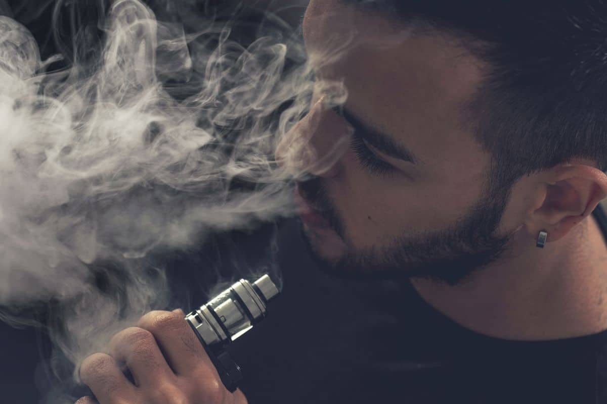 A guy having wonderful vaping experience